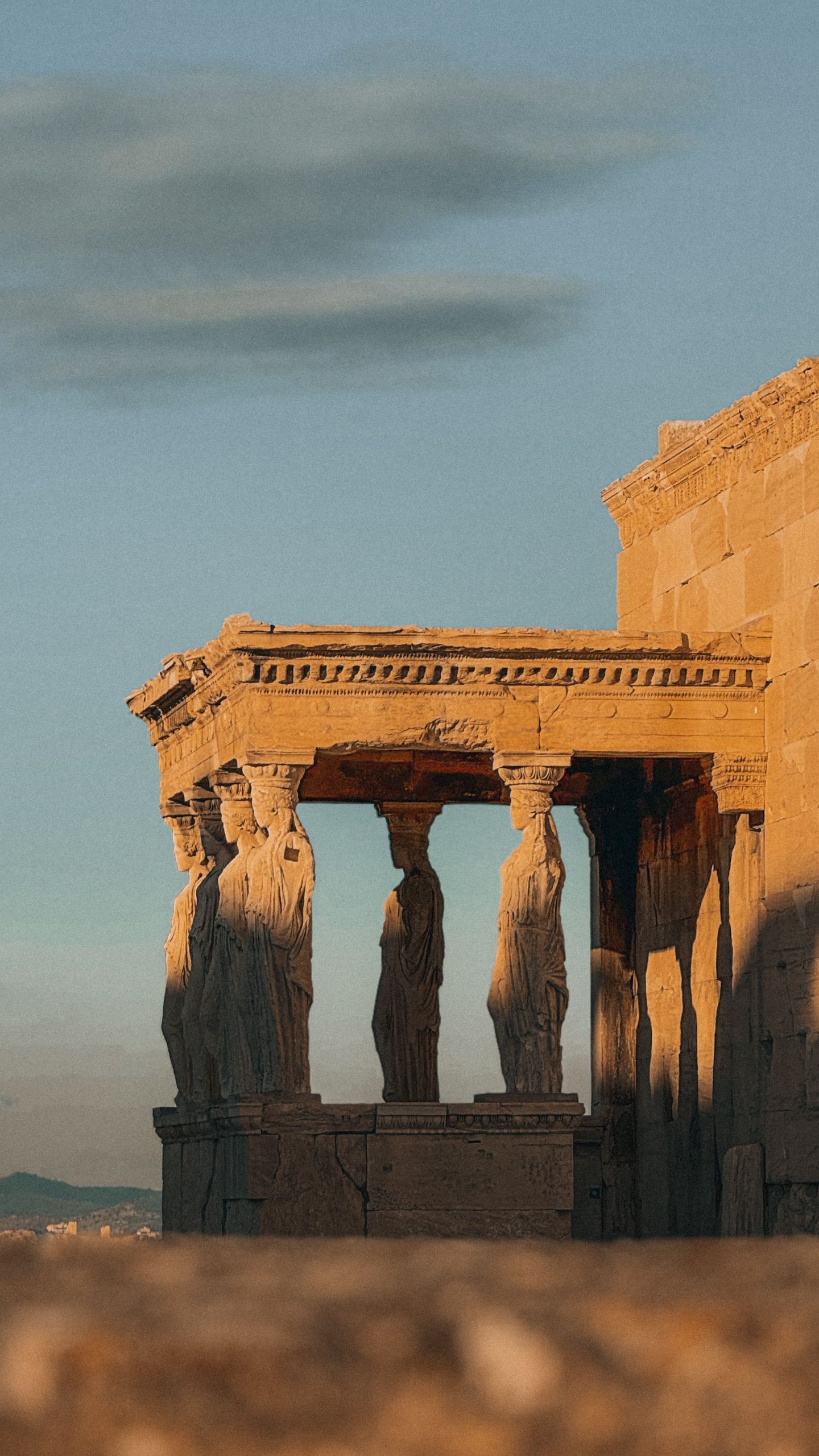 Sunset view of the Erechtheion Temple's Caryatids on the Acropolis in Athens, Greece.